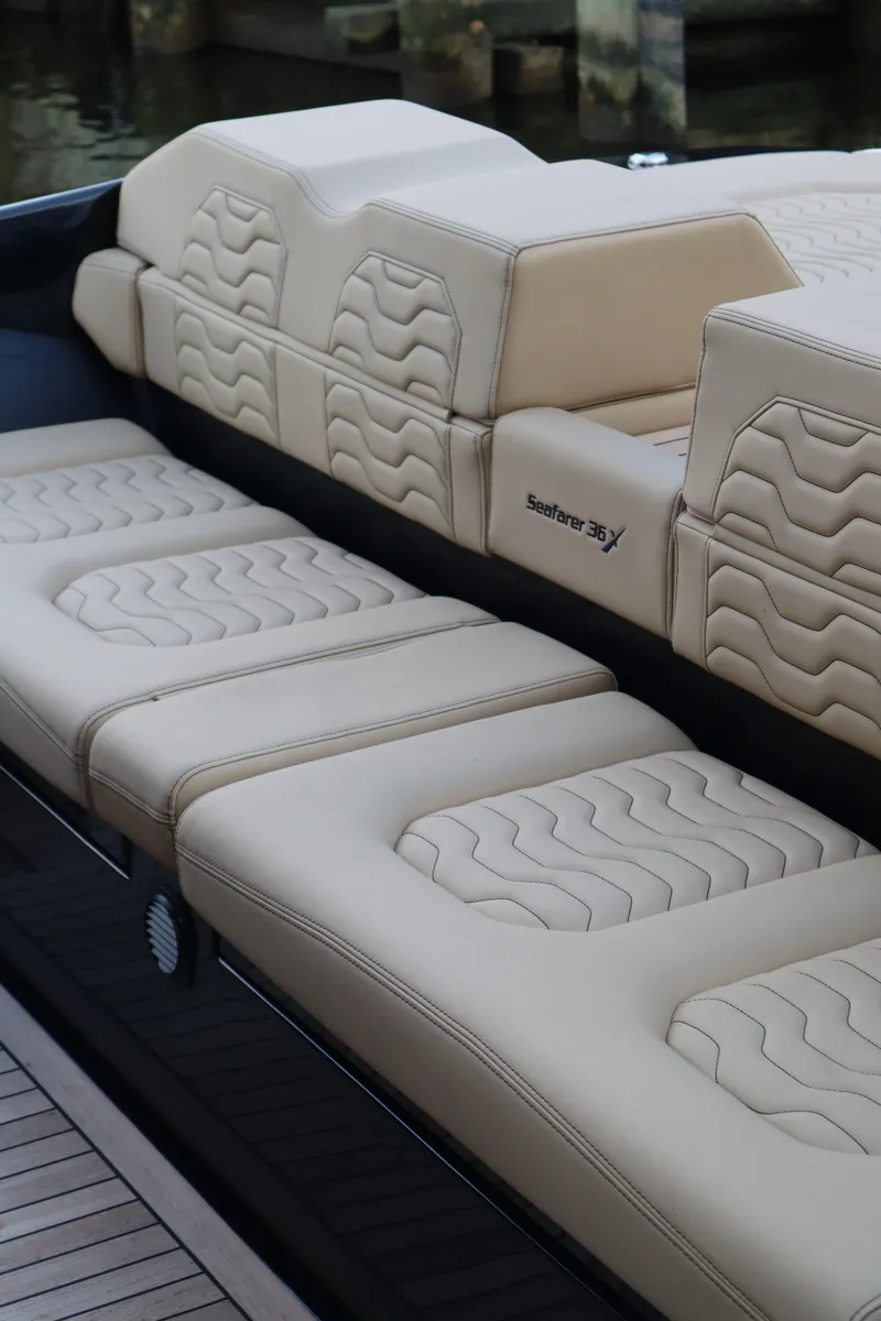 Slide: The Image of 2023 Ribco Seafarer 36 X boat with beige cushioned seating. - 23