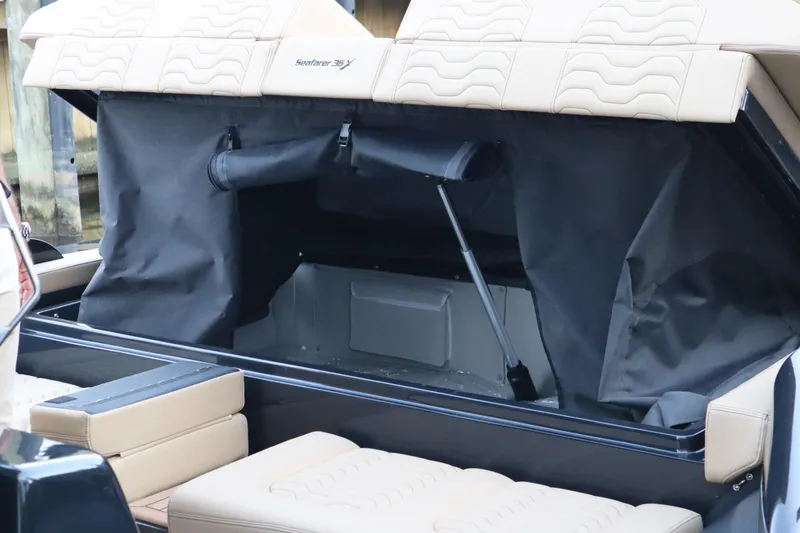 Slide: The Image of 2023 Ribco Seafarer 36 X boat interior storage compartment with beige seating. - 26