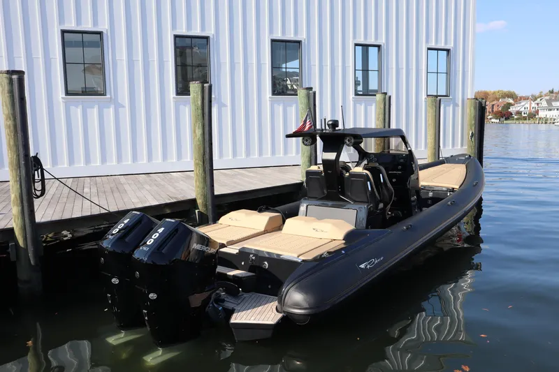 Slide: The Image of 2023 Ribco Seafarer 36 X boat docked, featuring dual Mercury engines. - 4