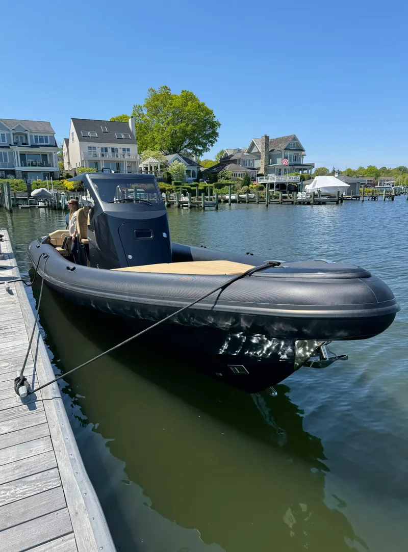 Slide: The Image of 2023 Ribco Seafarer 36 X boat docked by waterfront homes. - 6