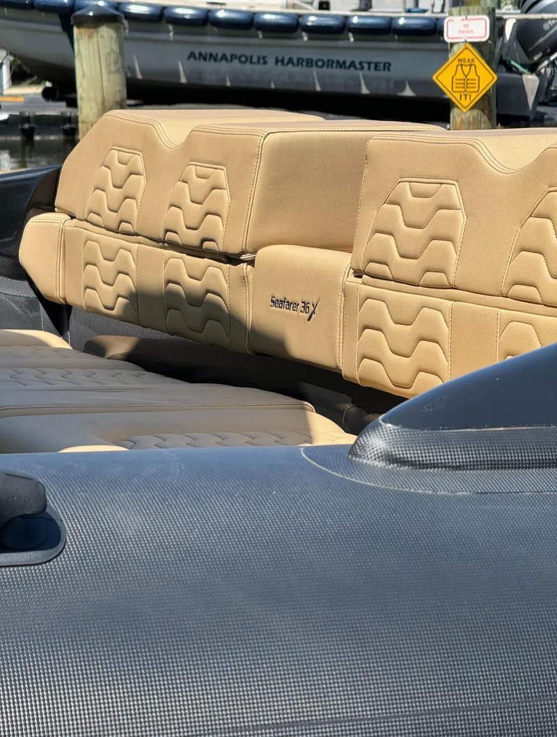 Slide: The Image of 2023 Ribco Seafarer 36 X boat with tan seating at Annapolis dock. - 9