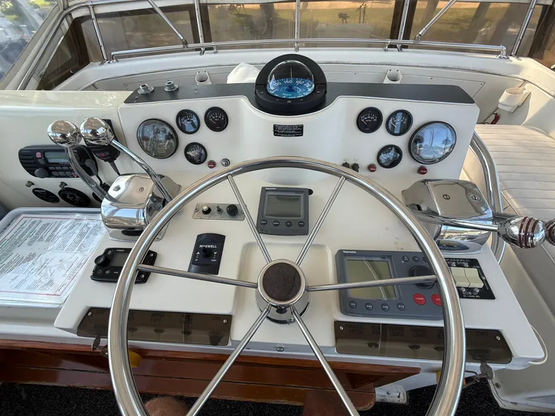 Slide: The Image of 1980 Viking 43 Double Cabin helm with steering wheel, gauges, and navigation equipment. - 10