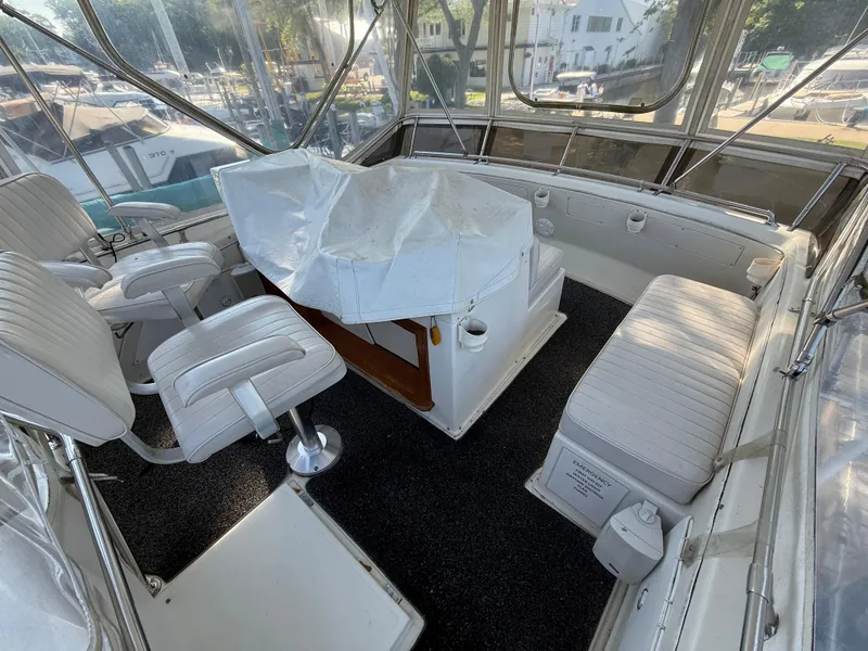 Slide: The Image of 1980 Viking 43 Double Cabin interior with white seating and covered controls. - 13