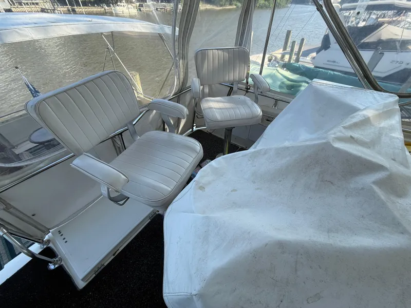 Slide: The Image of 1980 Viking 43 Double Cabin interior with white seating and covered console. - 14
