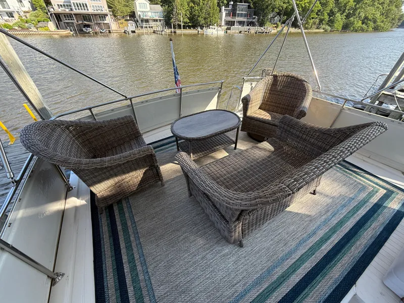 Slide: The Image of Outdoor seating on 1980 Viking 43 Double Cabin yacht, overlooking serene waterfront. - 15