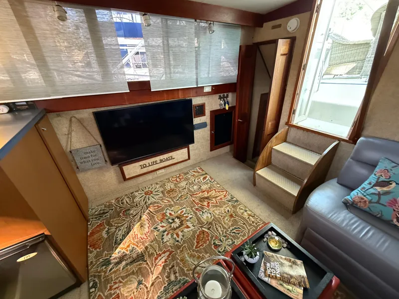 Slide: The Image of Interior of 1980 Viking 43 Double Cabin with TV, stairs, and decorative rug. - 17