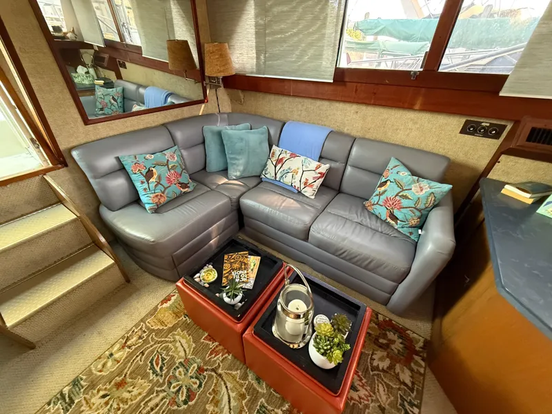 Slide: The Image of Cozy interior of 1980 Viking 43 Double Cabin with plush seating and decorative pillows. - 19