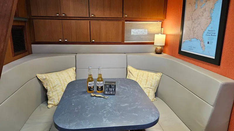 Slide: The Image of Cozy 1980 Viking 43 Double Cabin interior with table, drinks, and map decor. - 24