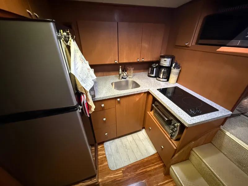 Slide: The Image of Compact kitchen in a 1980 Viking 43 Double Cabin yacht with modern appliances. - 26