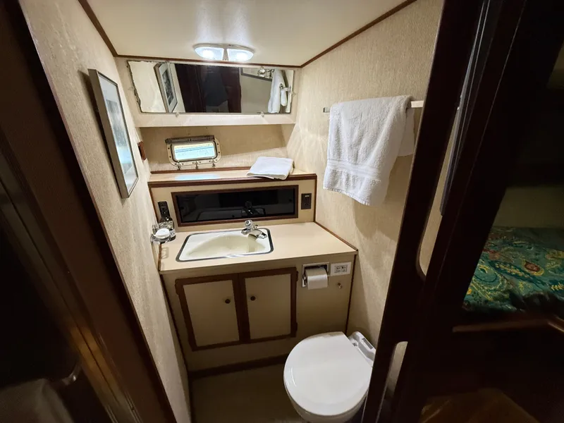 Slide: The Image of 1980 Viking 43 Double Cabin bathroom with sink, mirror, and towel rack. - 31