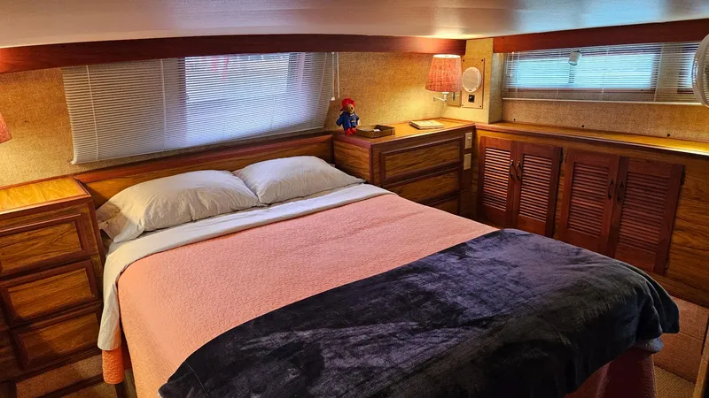 Slide: The Image of Cozy bedroom in 1980 Viking 43 Double Cabin yacht with wood furnishings and soft lighting. - 35