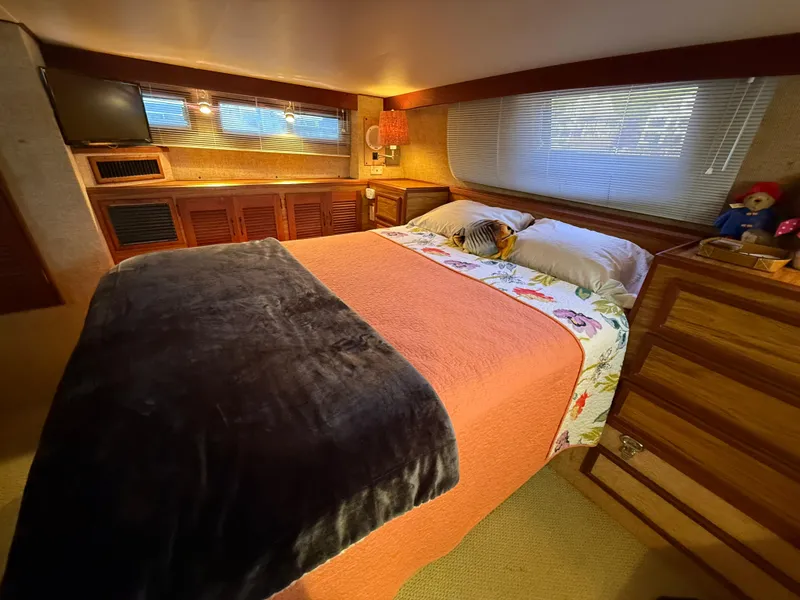 Slide: The Image of Cozy bedroom in 1980 Viking 43 Double Cabin yacht with plush bedding and wooden cabinetry. - 36