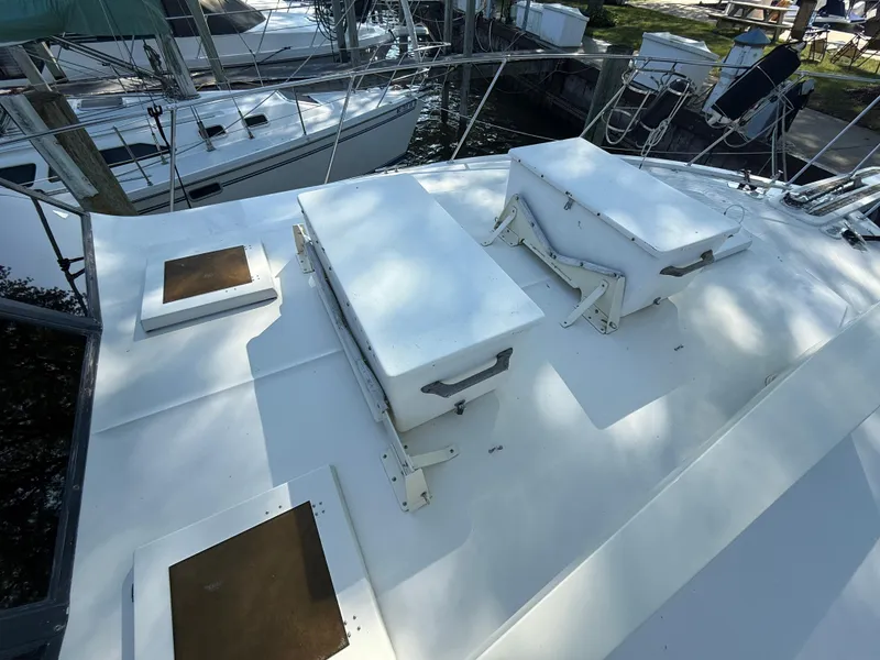 Slide: The Image of 1980 Viking 43 Double Cabin boat deck with hatches, docked at marina. - 5