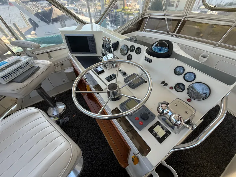 Slide: The Image of 1980 Viking 43 Double Cabin helm with steering wheel, gauges, and navigation equipment. - 9