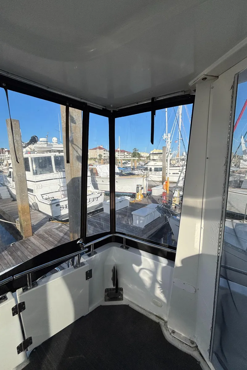 Slide: The Image of 2001 Carver 396 Aft Cabin MY interior view with marina backdrop. - 18