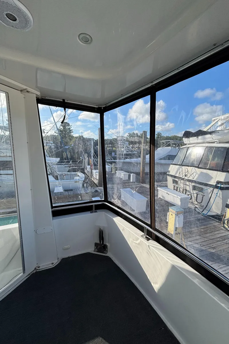 Slide: The Image of 2001 Carver 396 Aft Cabin MY interior with marina view through large windows. - 20