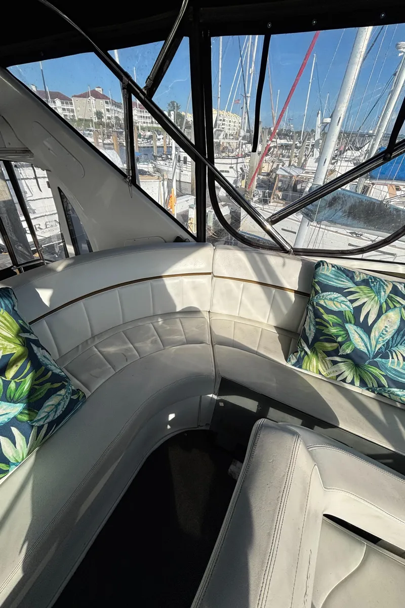 Slide: The Image of 2001 Carver 396 Aft Cabin MY interior with white seating and tropical cushions. - 34