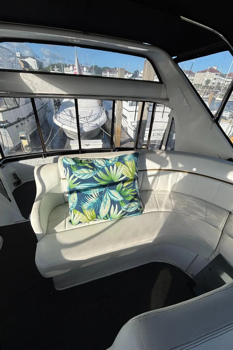 Slide: The Image of 2001 Carver 396 Aft Cabin MY interior with white seating and tropical cushion. - 35