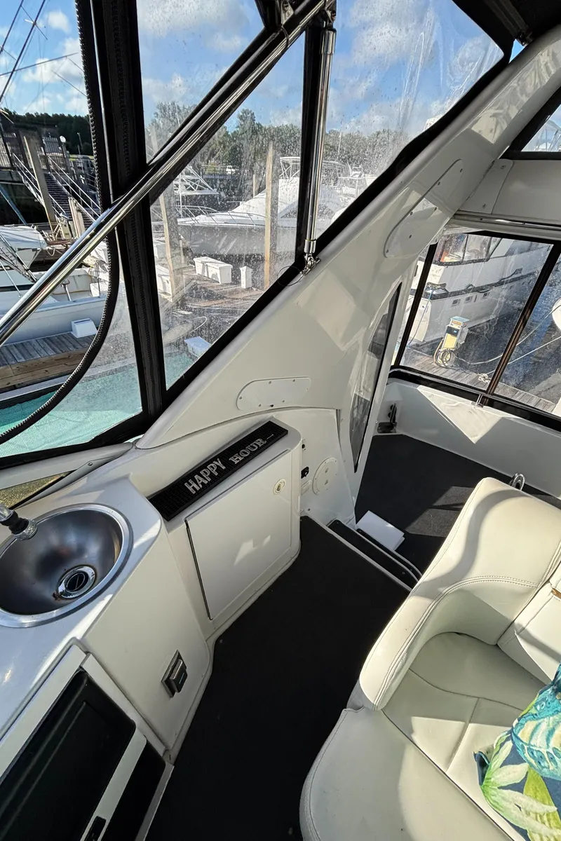 Slide: The Image of 2001 Carver 396 Aft Cabin MY interior with sink and seating, docked at marina. - 36