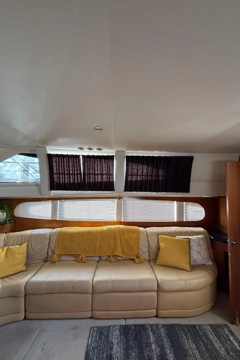 Slide: The Image of Interior of 2001 Carver 396 Aft Cabin MY with beige sofa and yellow accents. - 45