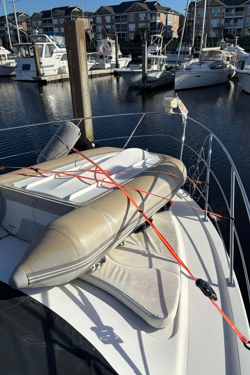 Slide: The Image of 2001 Carver 396 Aft Cabin MY with inflatable boat on deck, docked at marina. - 15