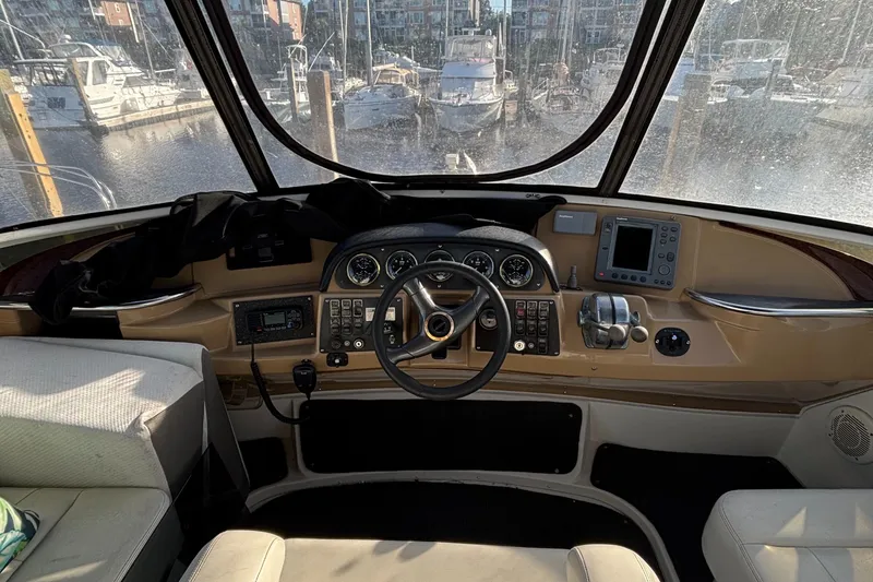 Slide: The Image of 2001 Carver 396 Aft Cabin MY helm with steering wheel and navigation controls. - 26