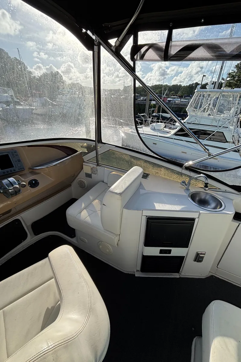 Slide: The Image of Interior view of 2001 Carver 396 Aft Cabin MY yacht with helm and seating area. - 31