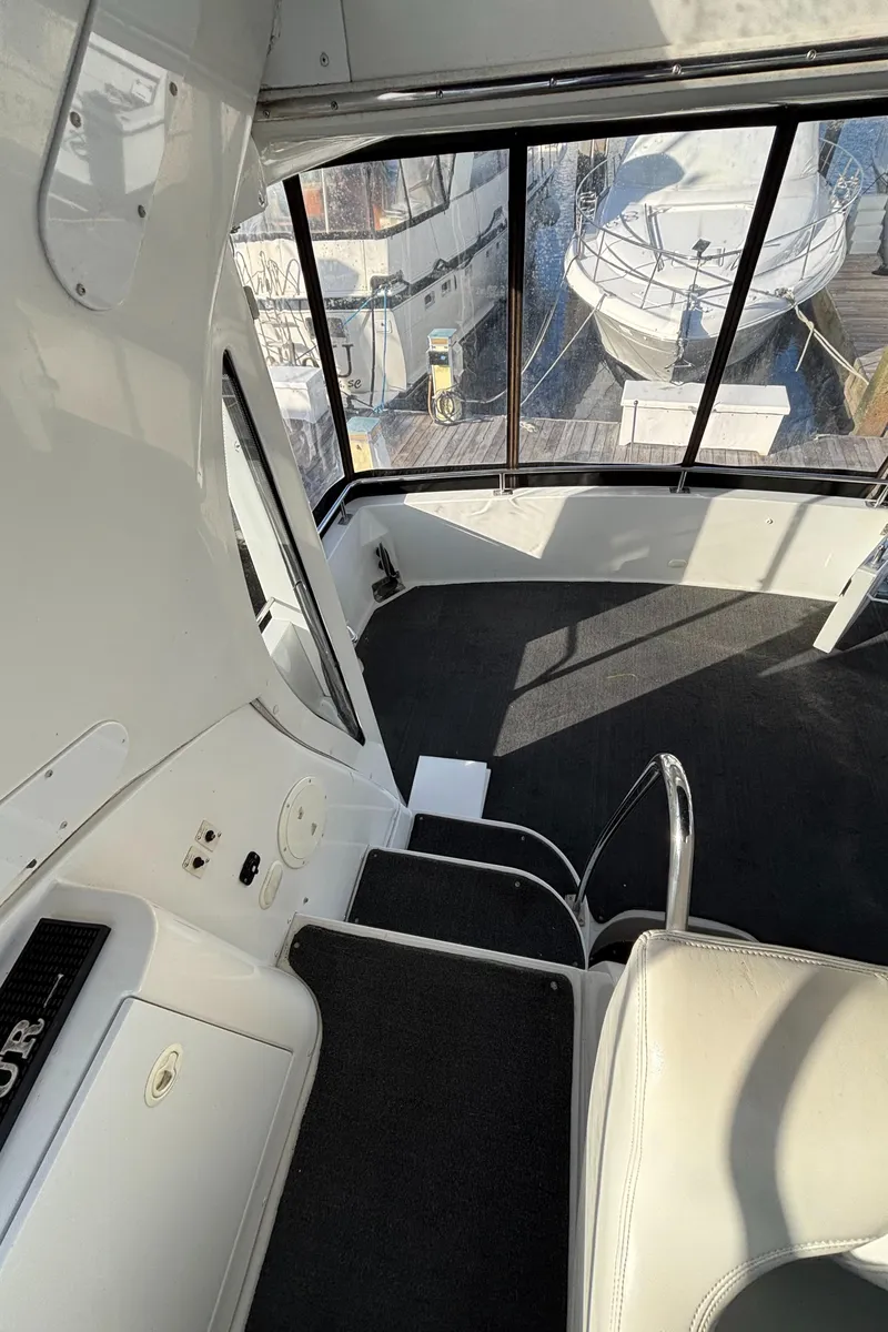 Slide: The Image of 2001 Carver 396 Aft Cabin MY interior with seating and marina view. - 41