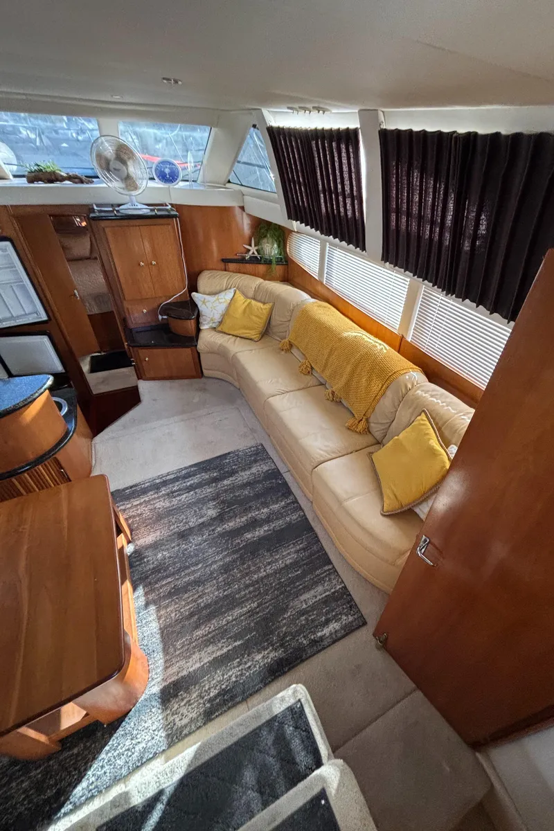 Slide: The Image of Interior of 2001 Carver 396 Aft Cabin MY with beige sofa and yellow accents. - 43