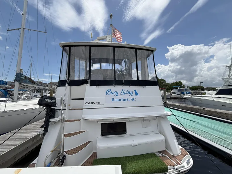 Slide: The Image of 2001 Carver 396 Aft Cabin MY docked, featuring "Busy Living" from Beaufort, SC. - 5