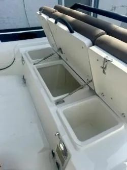 Slide: The Image of 2026 Brig Navigator boat with open storage compartments and cushioned seating. - 6