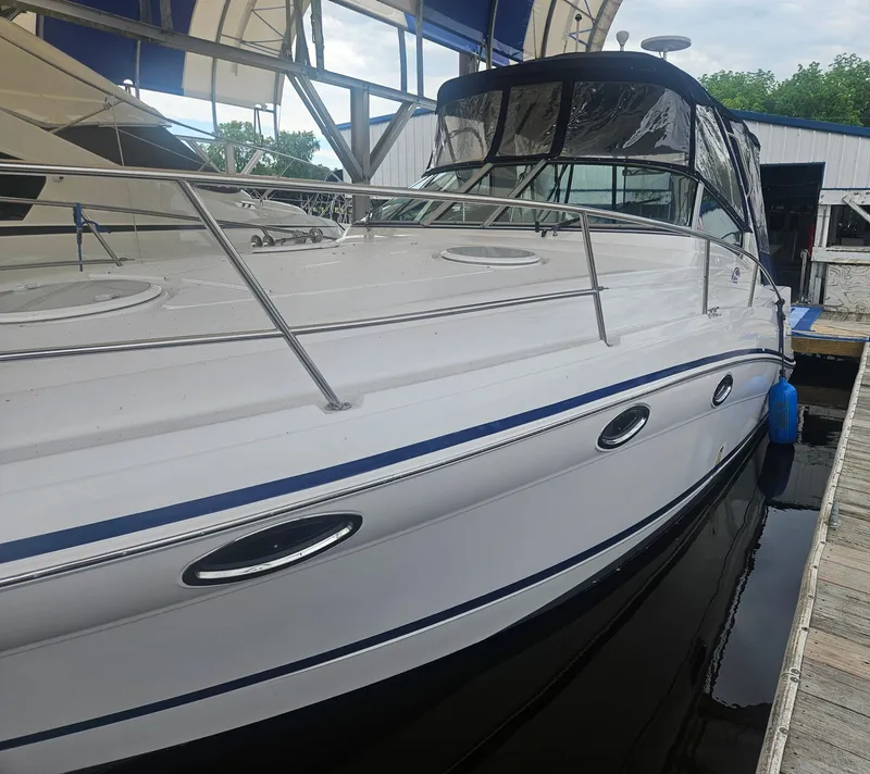 Slide: The Image of 2006 Four Winns 318 Vista boat docked, featuring sleek design and modern amenities. - 10