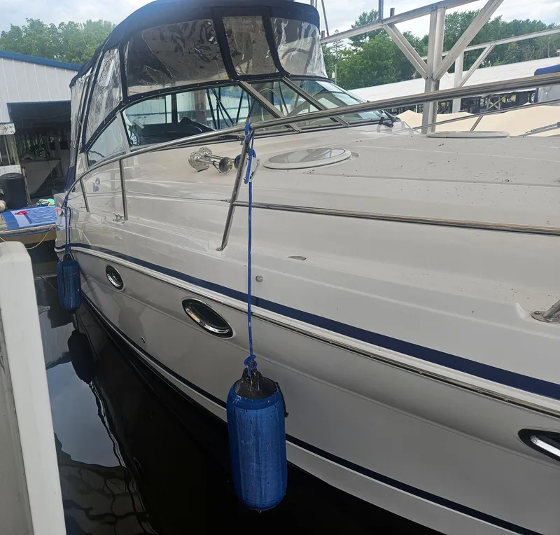 Slide: The Image of 2006 Four Winns 318 Vista boat docked with blue fenders, covered cockpit. - 11
