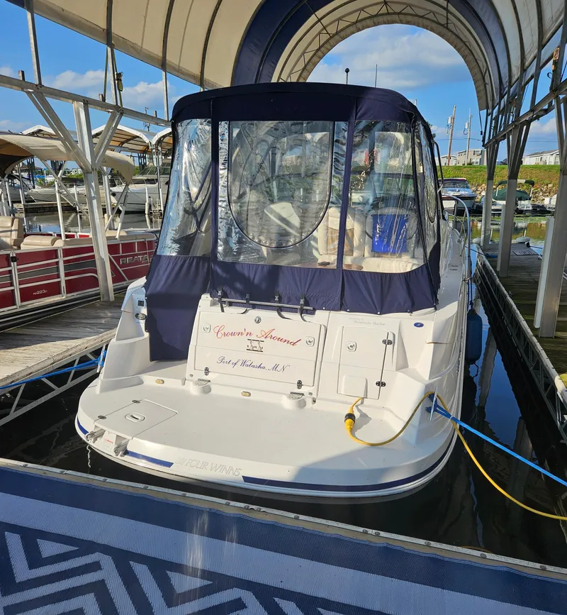 Slide: The Image of 2006 Four Winns 318 Vista boat docked under canopy, rear view. - 12