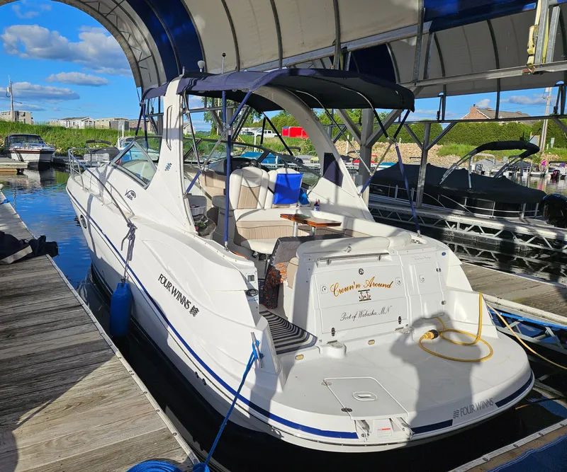 Slide: The Image of 2006 Four Winns 318 Vista boat docked under a canopy on a sunny day. - 13
