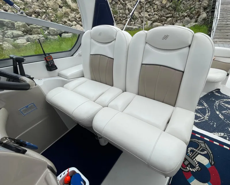 Slide: The Image of 2006 Four Winns 318 Vista boat interior with white leather seats and control panel. - 17