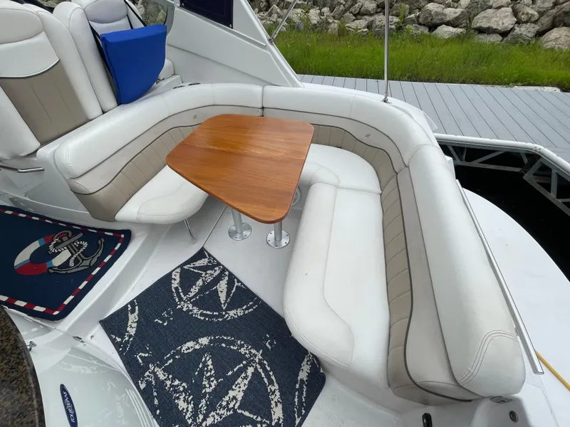 Slide: The Image of 2006 Four Winns 318 Vista boat interior with white seating and wooden table. - 19