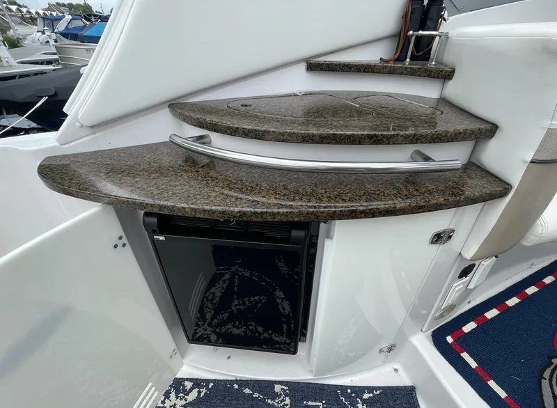 Slide: The Image of 2006 Four Winns 318 Vista boat interior with granite countertops and mini fridge. - 20