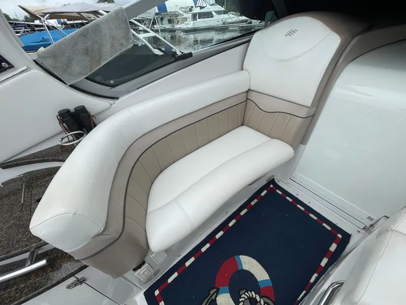 Slide: The Image of 2006 Four Winns 318 Vista boat interior with white seating and nautical-themed mat. - 21