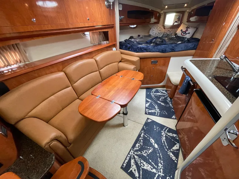 Slide: The Image of Luxurious 2006 Four Winns 318 Vista cabin interior with cozy seating and modern amenities. - 25