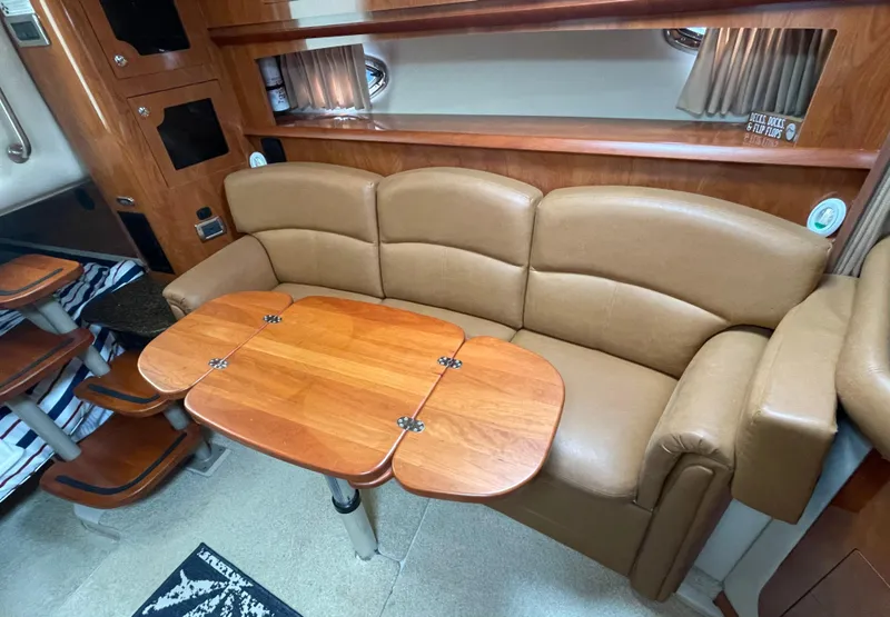 Slide: The Image of Luxurious interior of 2006 Four Winns 318 Vista with leather seating and wooden table. - 28