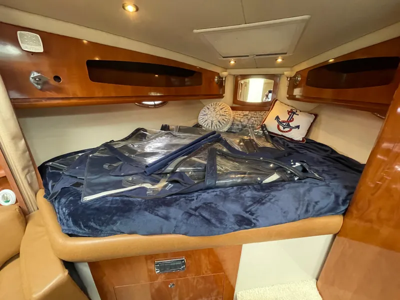 Slide: The Image of 2006 Four Winns 318 Vista cabin interior with cozy bedding and nautical decor. - 29