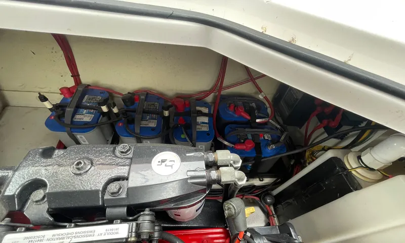 Slide: The Image of Engine compartment of 2006 Four Winns 318 Vista with multiple marine batteries. - 36