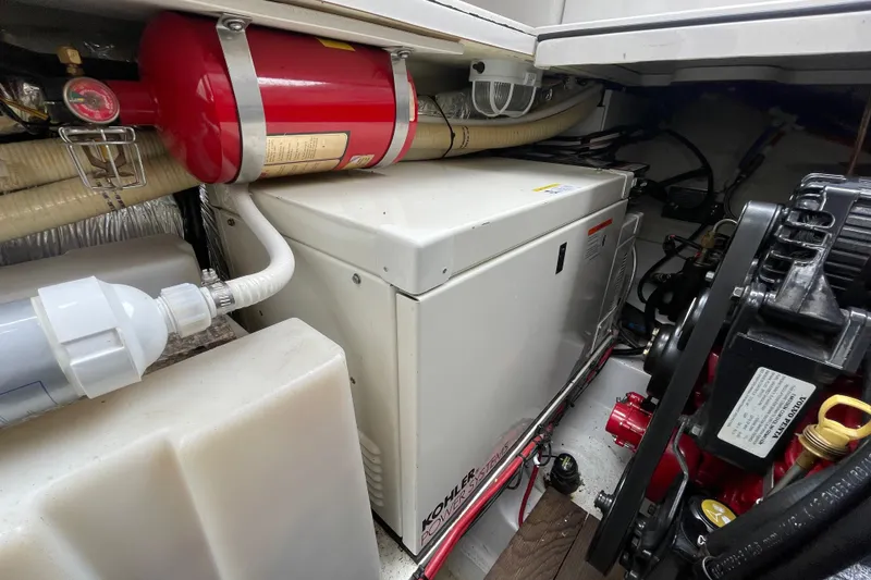 Slide: The Image of Engine compartment of 2006 Four Winns 318 Vista with generator and fire extinguisher. - 38