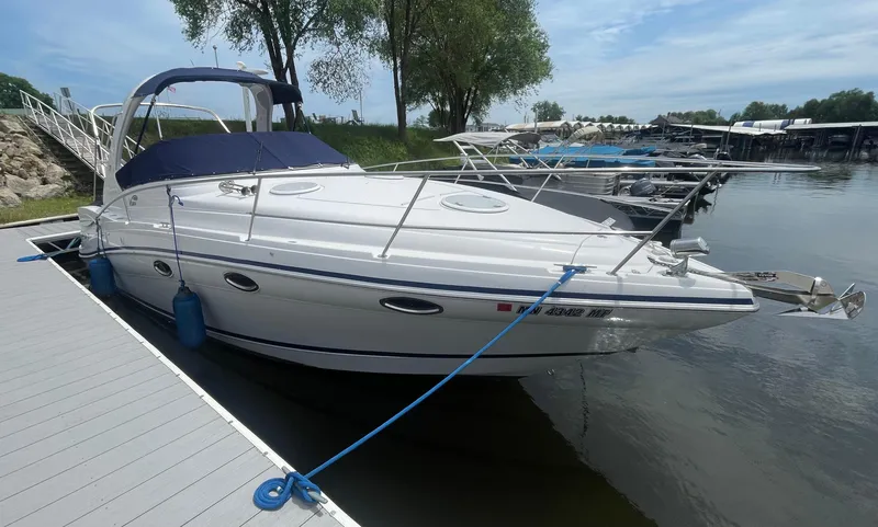 Slide: The Image of 2006 Four Winns 318 Vista boat docked at a marina on a sunny day. - 4