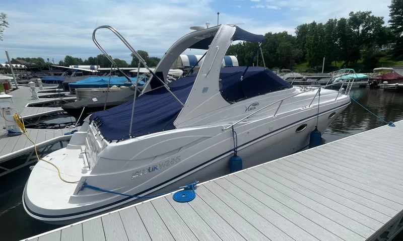 Slide: The Image of 2006 Four Winns 318 Vista boat docked at marina, covered with blue canopy. - 5