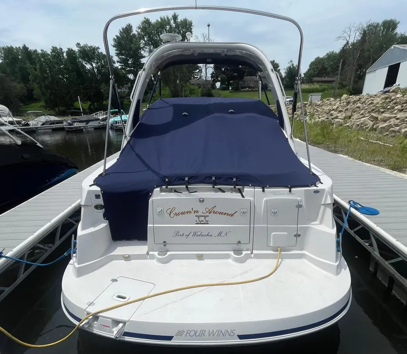 Slide: The Image of 2006 Four Winns 318 Vista boat docked with blue cover, rear view. - 6
