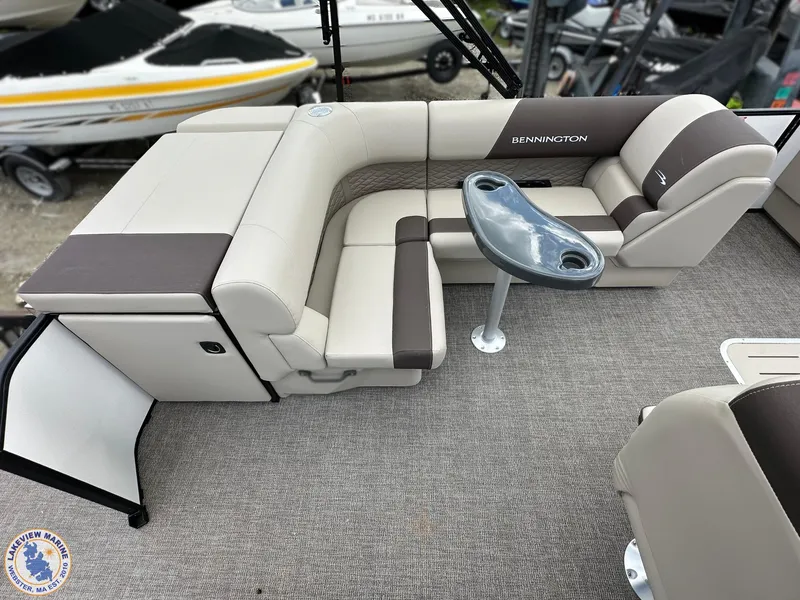 Slide: The Image of 2025 Bennington 21 SL pontoon boat interior with plush seating and table. - 10