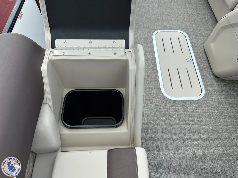 Slide: The Image of 2025 Bennington 21 SL boat interior with open storage compartment and carpeted floor. - 12