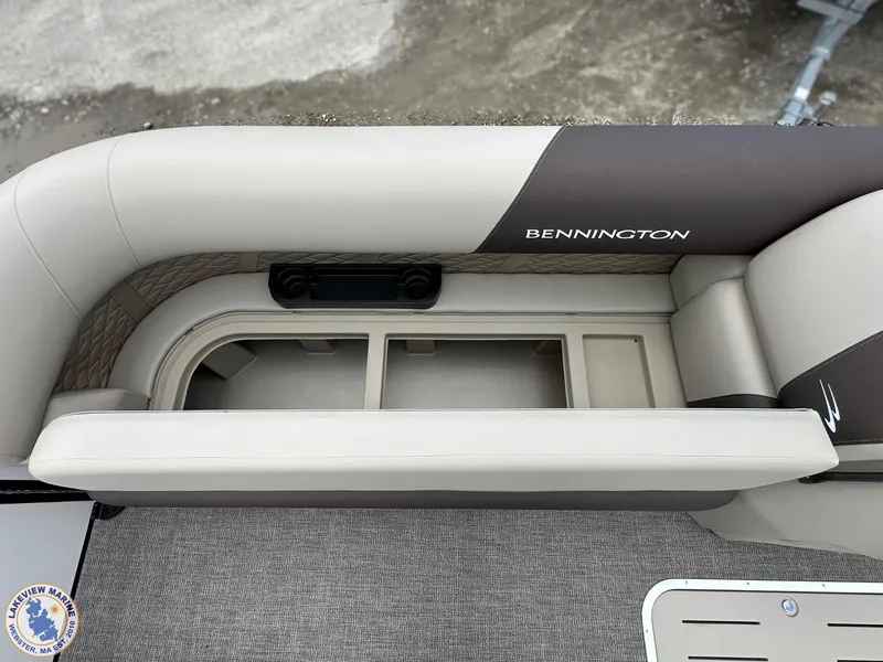 Slide: The Image of 2025 Bennington 21 SL boat interior with storage compartment and cushioned seating. - 5